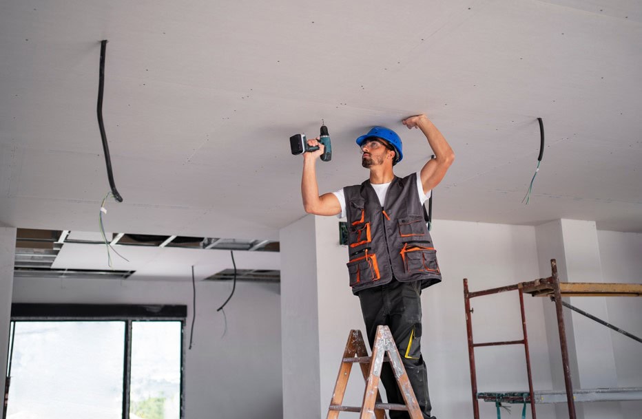 man repairing ceiling