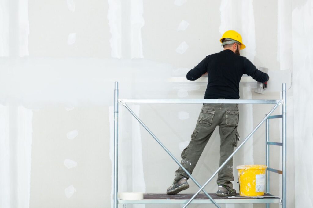 worker plastering gypsum board wall 1024x682